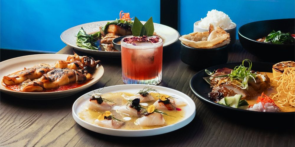 Share plates of Thai fusion dishes, and colourful cocktails in tall glasses.